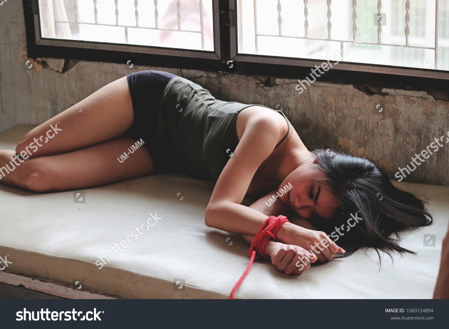 dark ema add women tied up to a bed photo